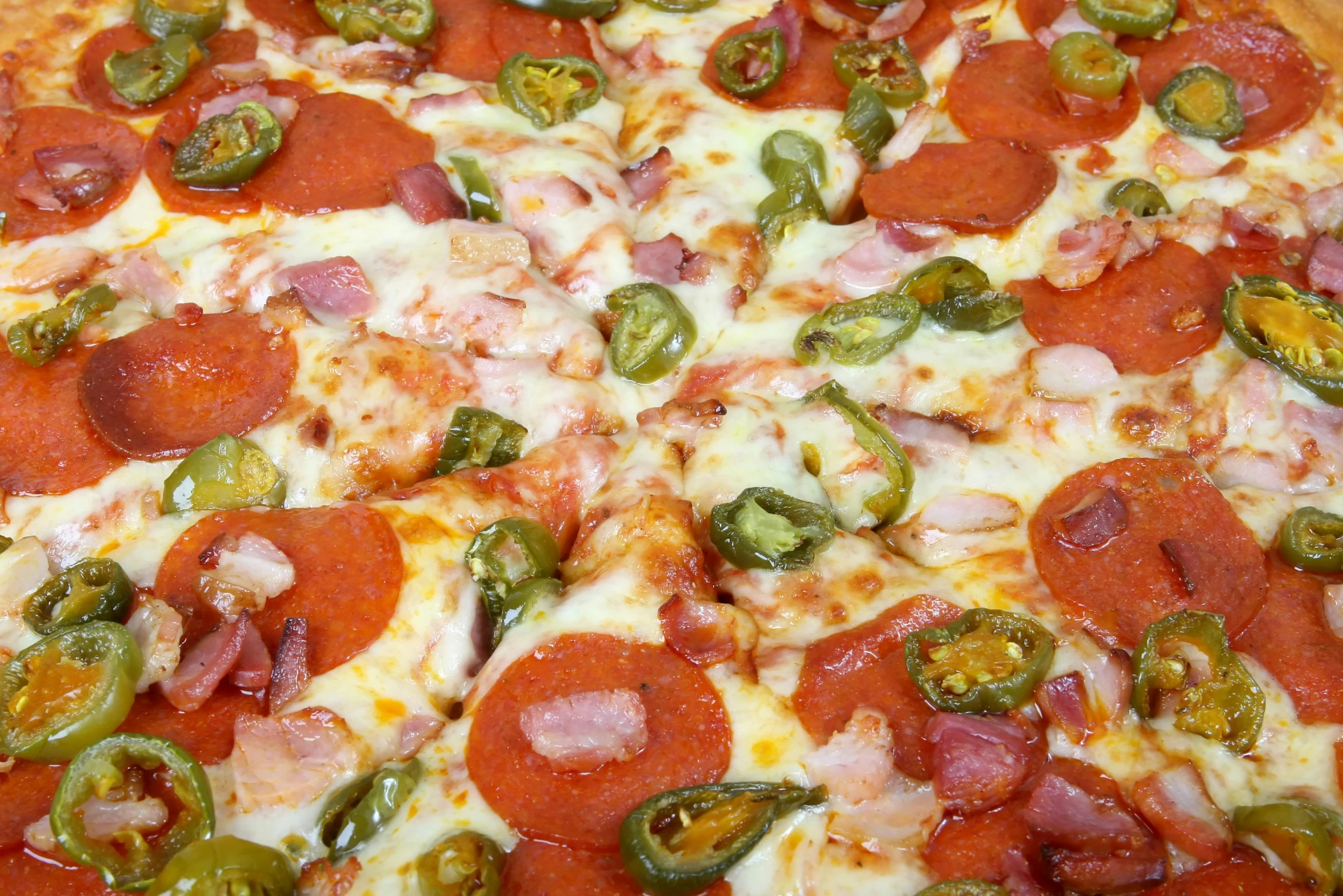 a close up of a pizza with pepperoni and jalapenos, by Bernie D’Andrea, order now, thumbnail, no cropping, close up photograph