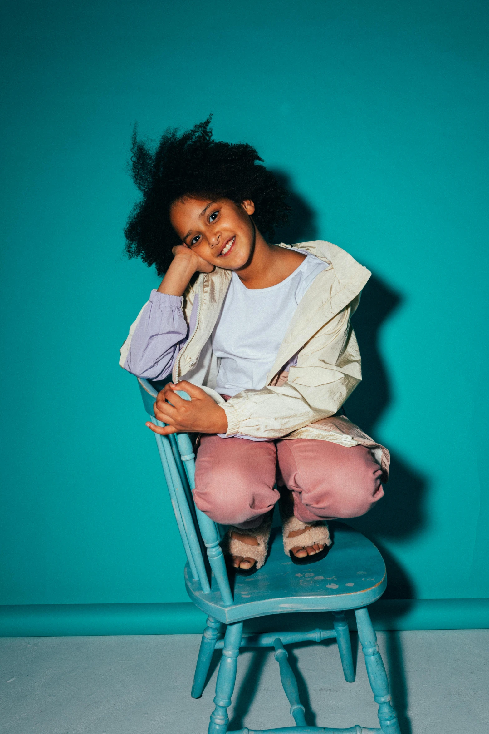 a woman sitting on top of a blue chair, super cute funky black girl, promo image, kids, mixed styles