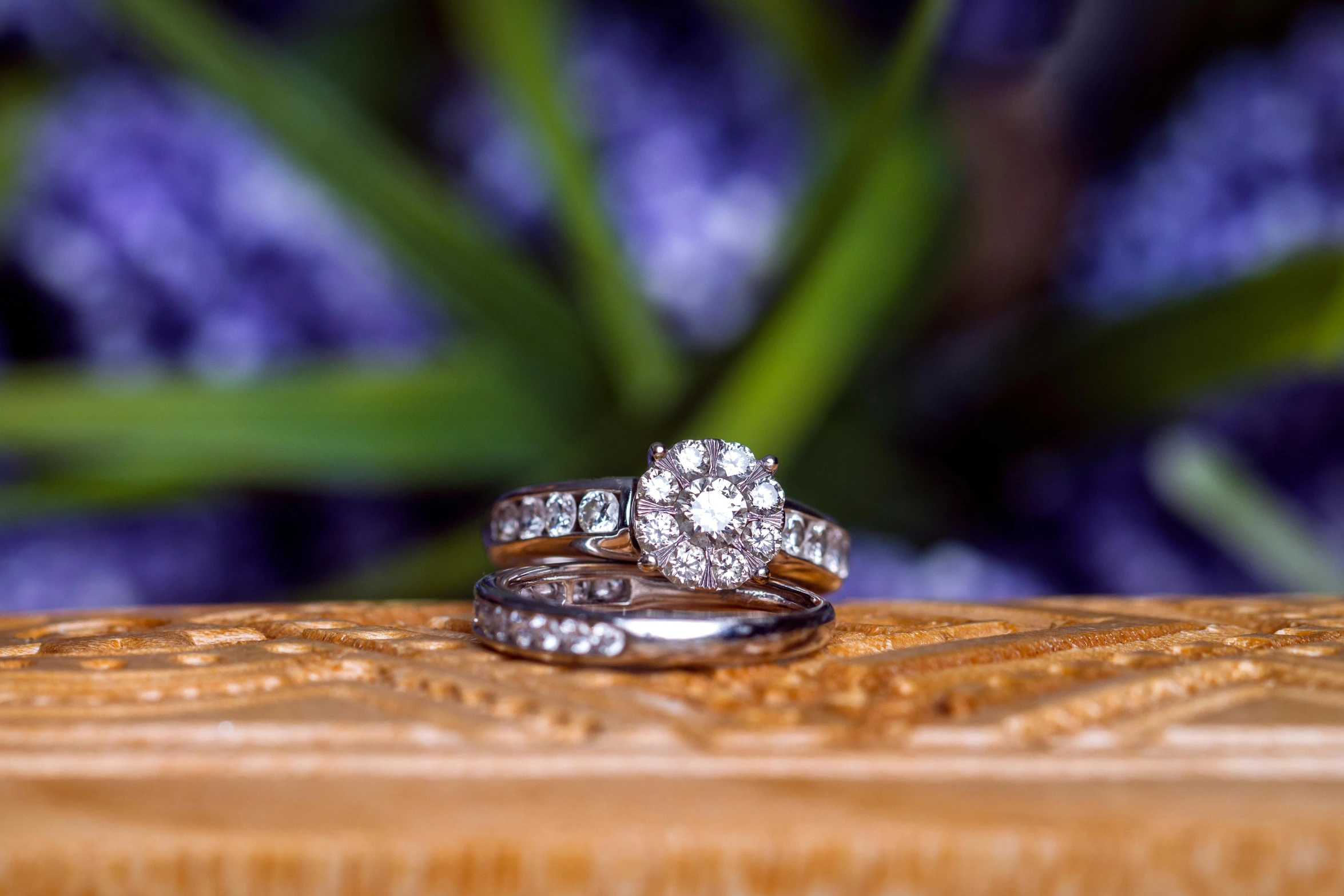 a couple of wedding rings sitting on top of a wooden table