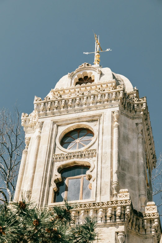 a clock tower with a weather vane on top of it, baroque, baroque marble and gold in space, tiny ornate windows, lisbon, 2019 trending photo