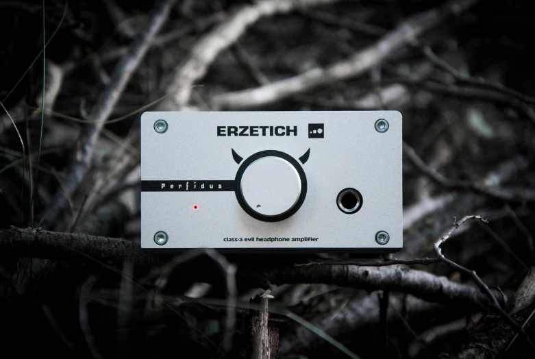 a white electronic device sitting on top of a tree branch, an album cover, by Lorentz Frölich, featured on reddit, audio equipments, zenith angle, amplified ritual engine, 1/2 pro mist filter