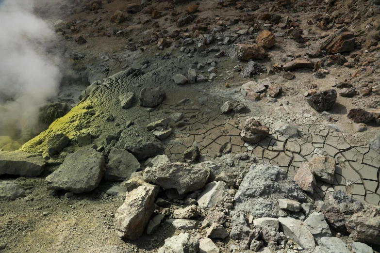 an image of a dirt field with steam rising up