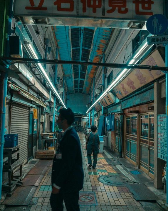 the interior of a subway station with men walking