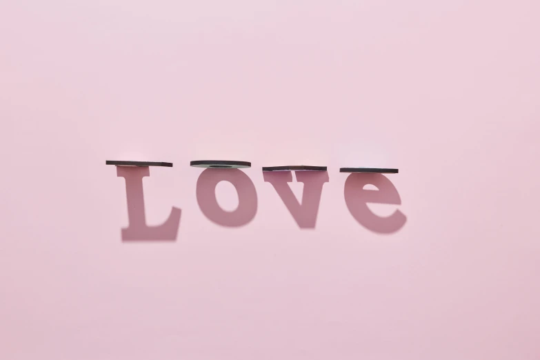a pink wall with the word love written on it, an album cover, inspired by Peter Alexander Hay, trending on pexels, shadows, shelf, 3d minimalistic, shot from below