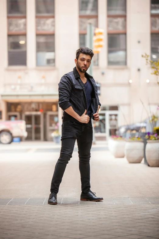 a man is standing on the street and posing for a po