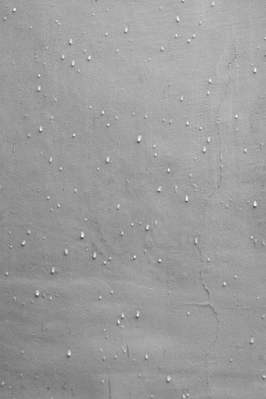 a man riding a snowboard down a snow covered slope, an ultrafine detailed painting, inspired by Vija Celmins, reddit, lots of raindrops, 144x144 canvas, plaster, grey - scale