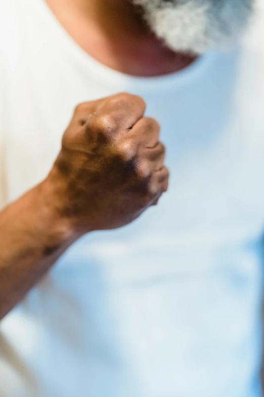 a man raising his fist and smiling for the camera