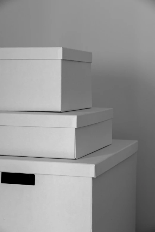 three white boxes stacked on top of each other, a black and white photo, no - text no - logo, digital image, ikea, image