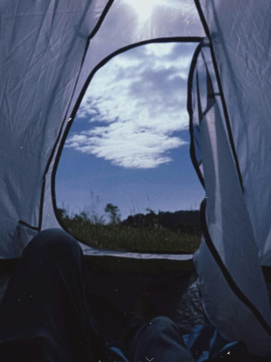 the inside of a tent with a view of the sky, happening, taken on a 2000s camera, on a hill, third-person view, ansel ]