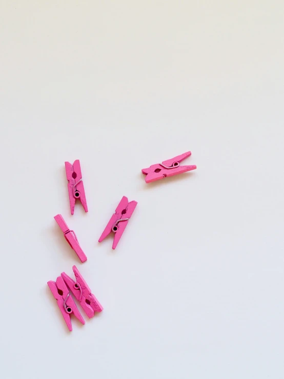 pink clips and clips on a white table