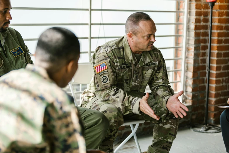 a group of men sitting around each other, multicam uniform, teaching, promo image, high - resolution