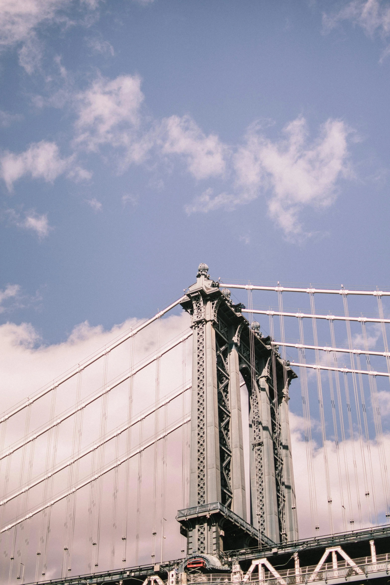a view of a bridge with a blue sky in the background, inspired by Thomas Struth, trending on unsplash, new york buildings, grey, tall golden heavenly gates, a quaint