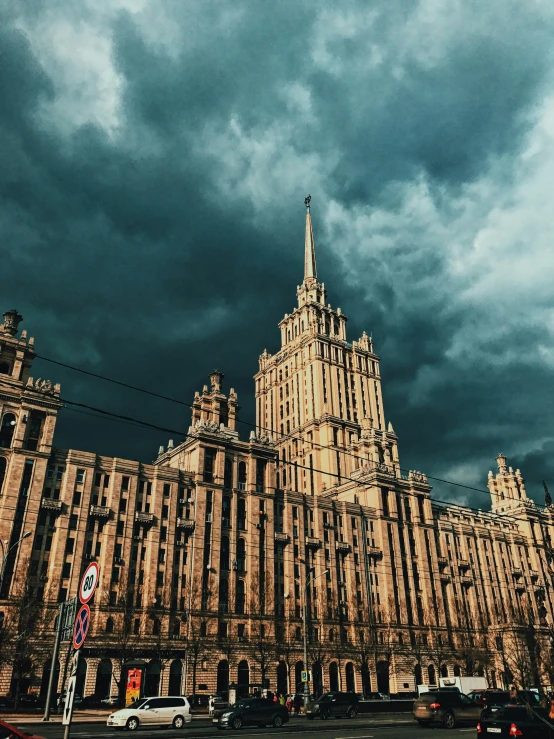 large buildings that are brown in color against a dark sky