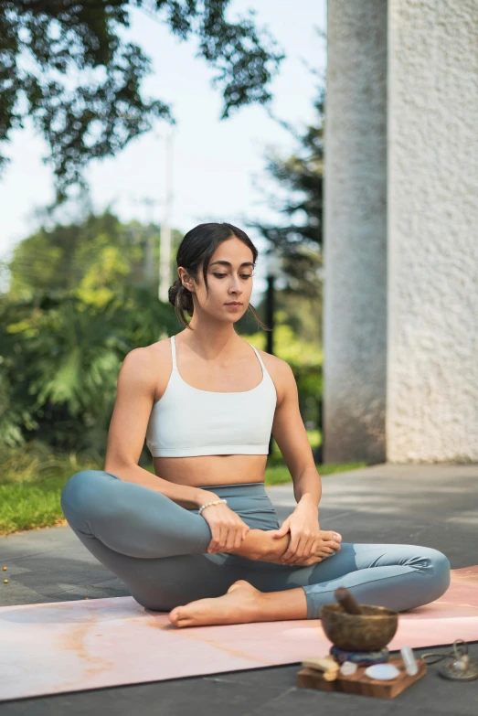 a woman sitting on her knees in a yoga position