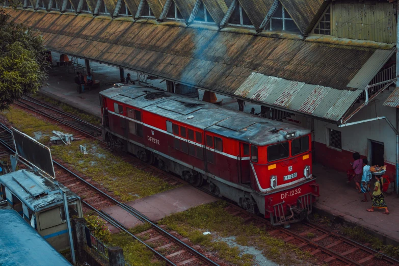 a red train pulling into a train station, by Adam Marczyński, pexels contest winner, photorealism, sri lanka, soviet yard, digital model, thumbnail