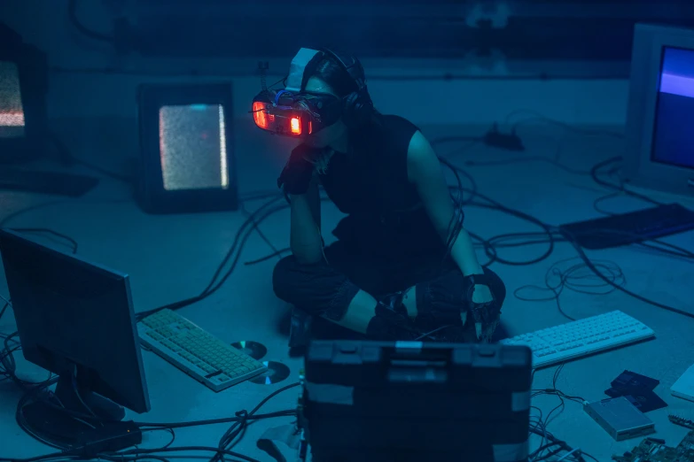 a person sitting on the floor in front of a computer, cyberpunk art, unsplash, serial art, wearing a vr headset, cyberpunk headpiece, calarts, sleek oled blue visor for eyes