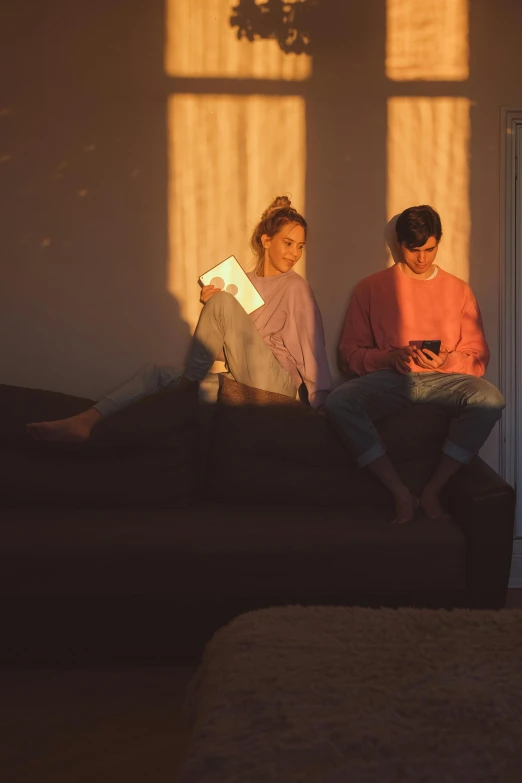 a couple of people that are sitting in a room, late afternoon, cinematic pastel lighting, relaxing on a couch, promo image