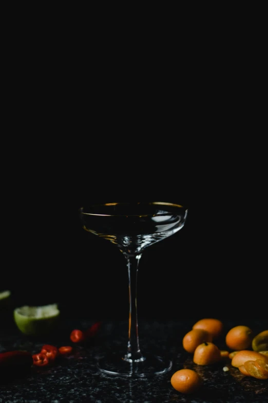 a martini glass sitting on top of a table, a still life, pexels contest winner, standing with a black background, fruit, thumbnail, multiple stories