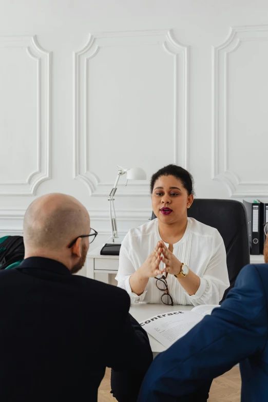 a group of people sitting around a table, in a white room, female lawyer, in paris, riyahd cassiem