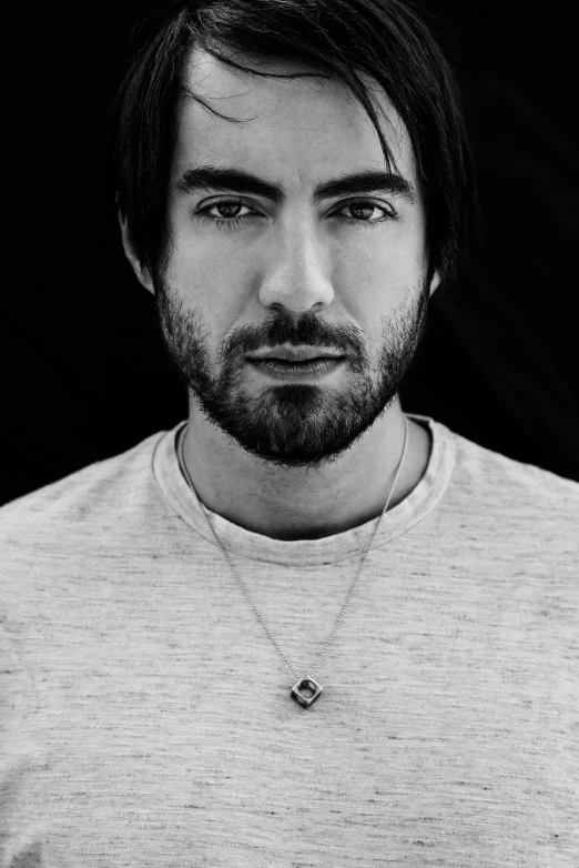 a young man in a shirt with a silver chain