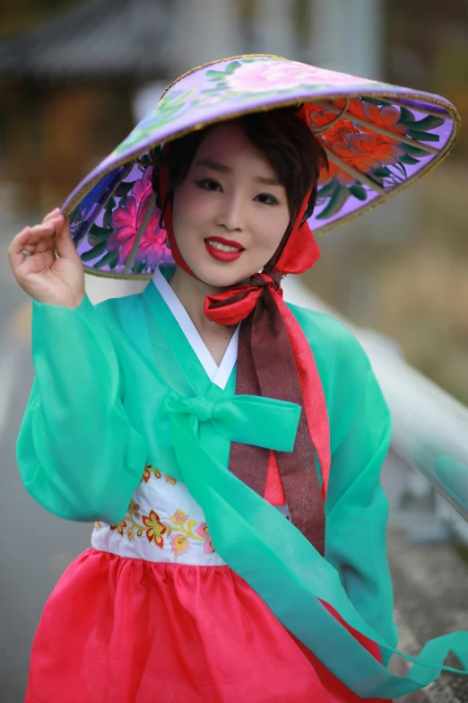 a woman in an asian hat with red and green colors