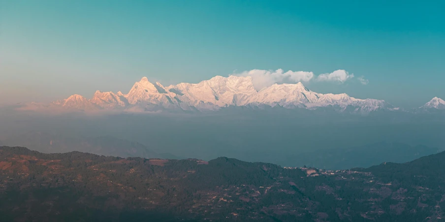 some mountains in the distance and trees and blue sky