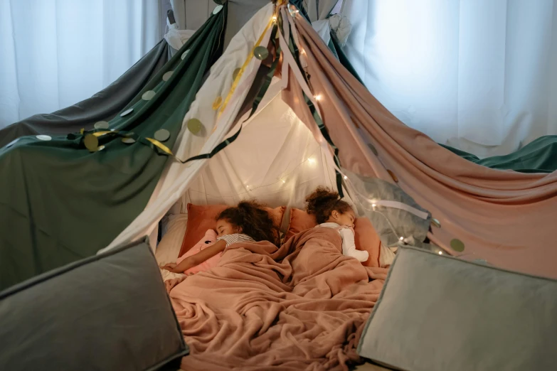 a couple of kids laying in a bed under a tent, by Adam Marczyński, pexels contest winner, decoration around the room, multiple stories, pink, string lights