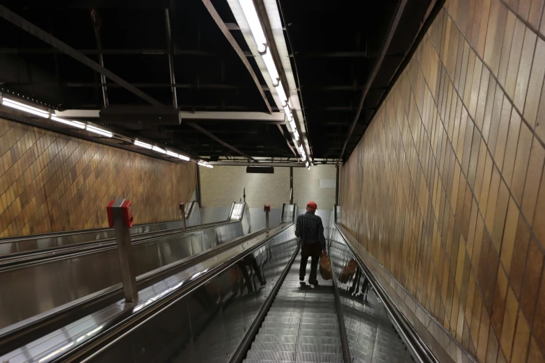 a couple of people walking down an escalator, maintenance area, brown, thumbnail, basement