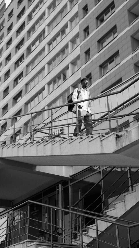 a couple of people that are standing on a bridge, a black and white photo, brutalism, highrise made up staircases, 8k octan photo, cinematic outfit photo, eyelevel!!! view!!! photography