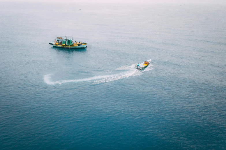 people on their motorboats in the middle of the ocean