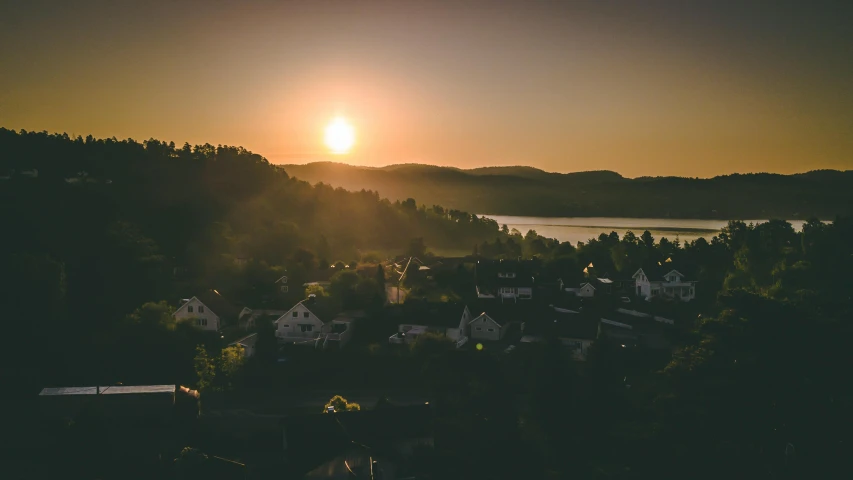 the sun is setting over a small town, pexels contest winner, swedish countryside, waking up, high angle shot, lake view