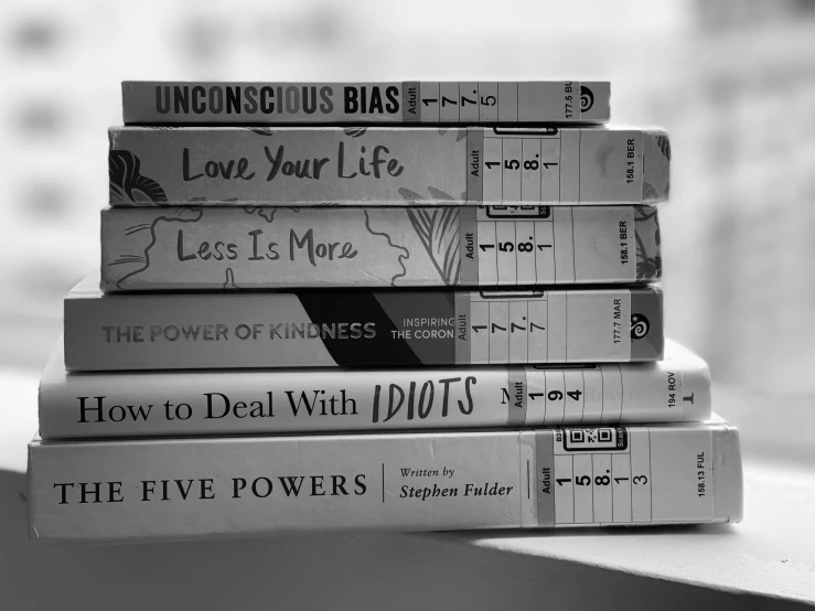 a stack of books sitting on top of a window sill, a black and white photo, by Caroline Mytinger, unsplash, fluxus, seven sins, infinite power, various posed, jen yoon