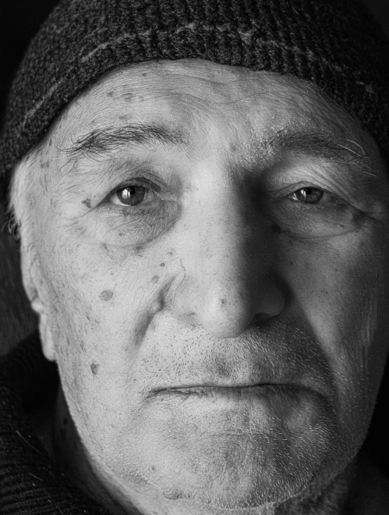 a black and white po of an older man with his eye opened