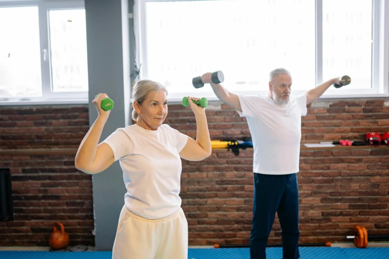 a man and a woman lifting dumbbells in a gym, pexels contest winner, two skinny old people, slightly sunny, avatar image, no cropping