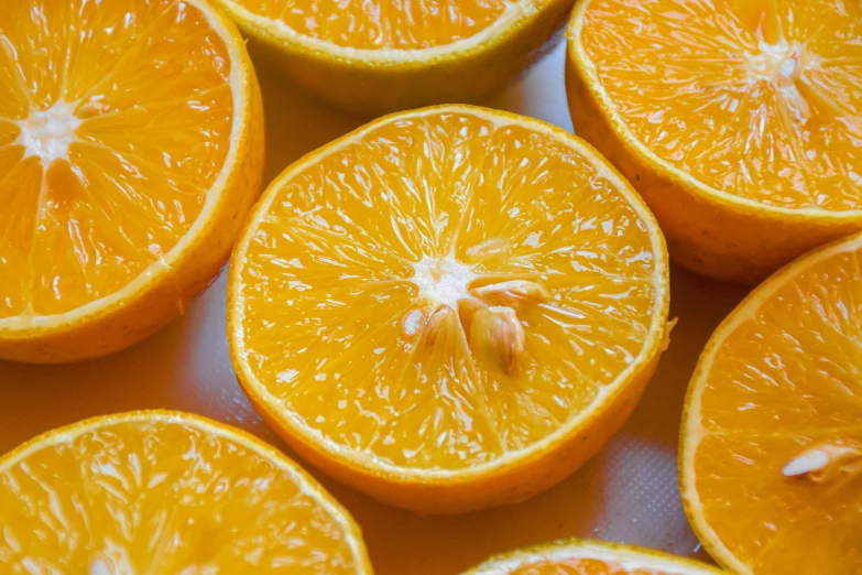 a close up of an orange sliced in half, by Carey Morris, pexels, 🦩🪐🐞👩🏻🦳, recipe, yellow, group photo