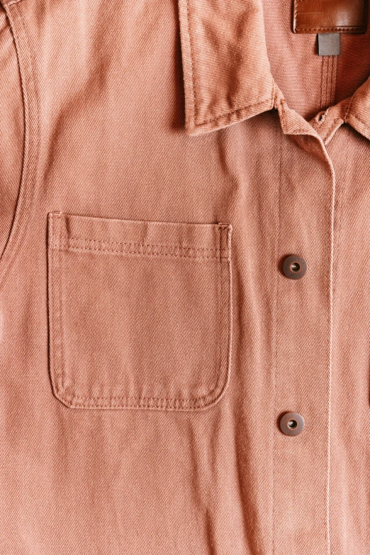 a close up view of a peach colored shirt