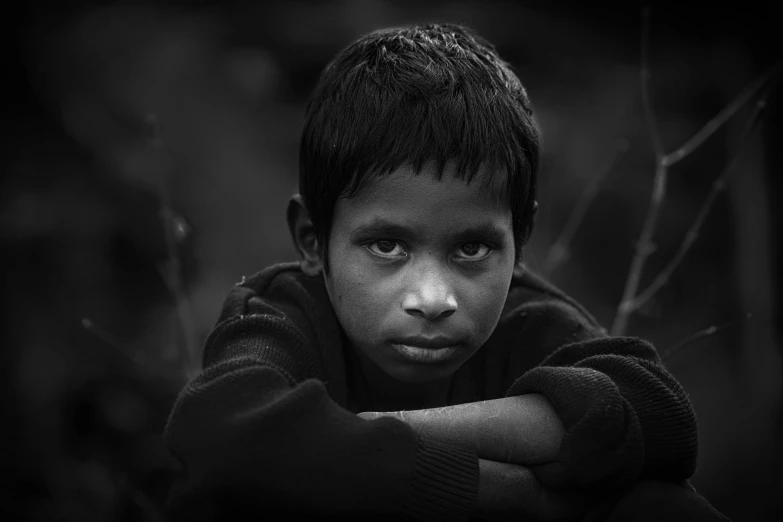 a black and white photo of a young boy, by Saurabh Jethani, pexels contest winner, realism, looking serious, sad man, young girl, posed