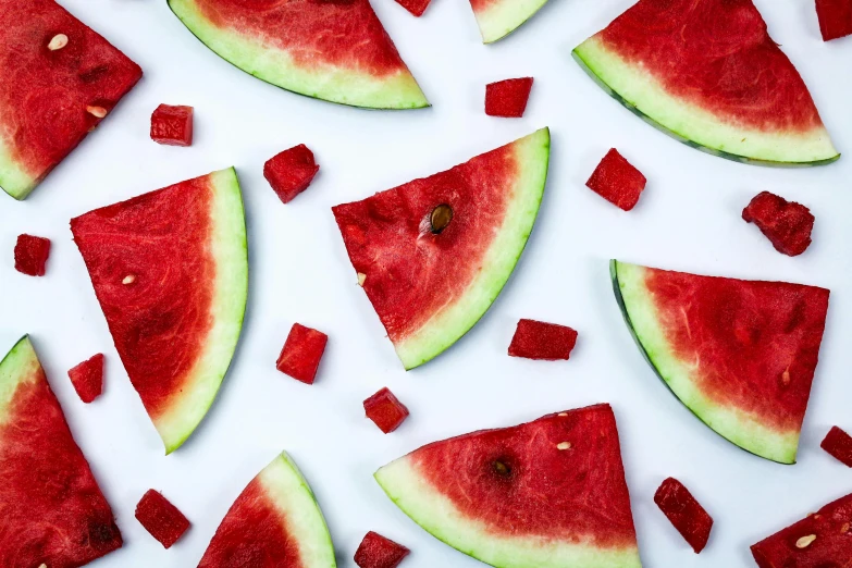 slices of watermelon on a white surface, by Julia Pishtar, pexels, gummy bears, squares, vibrant red 8k, 🍸🍋