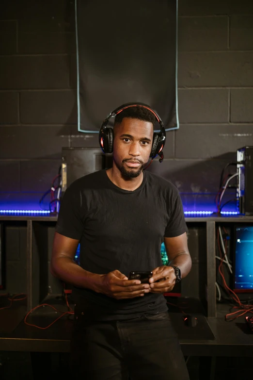 a man in a recording studio with headphones on, featured on reddit, black arts movement, rgb gamer toilet, portrait mode photo, proud serious expression, portrait photo of a backdrop