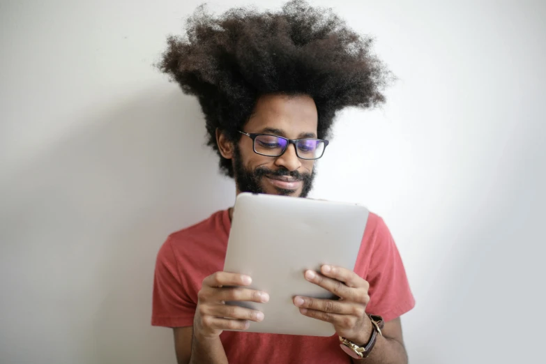 a man with a hair bun using his tablet