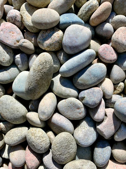 a pile of rocks sitting next to each other, detailed product image, smooth rounded shapes, beaching, multi colored