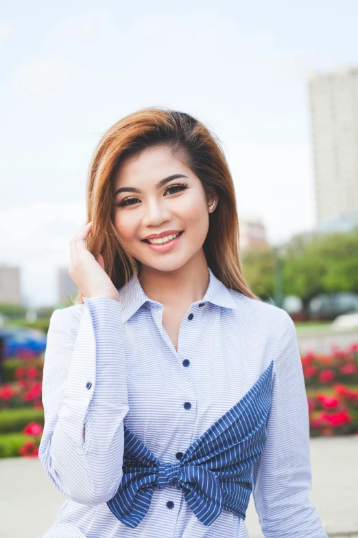 a woman with a blue bow tie posing for a picture, inspired by Ruth Jên, trending on unsplash, happening, wearing a shirt, square, mai anh tran, full frame image