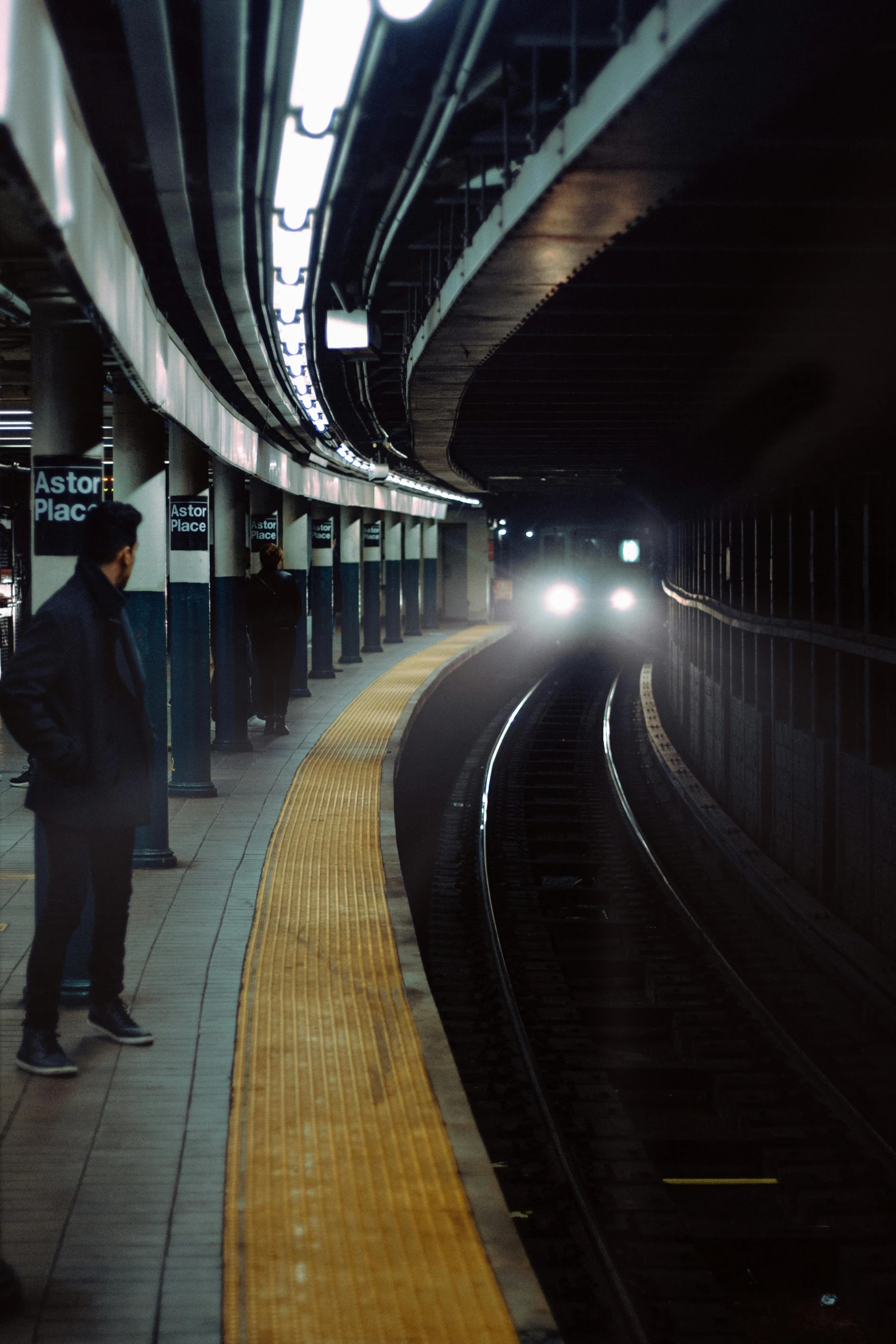 a man waiting for a train at a train station, inspired by Elsa Bleda, unsplash contest winner, hyperrealism, in the middle of new york, dark underground, dark. no text, instagram post