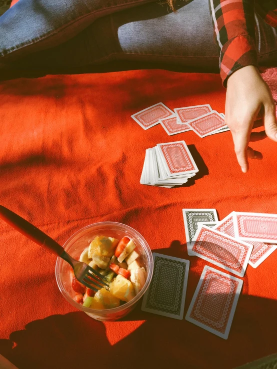 a person sitting at a table with a bowl of fruit and playing cards, by Julia Pishtar, pexels contest winner, red and grey only, college, instagram story, 15081959 21121991 01012000 4k