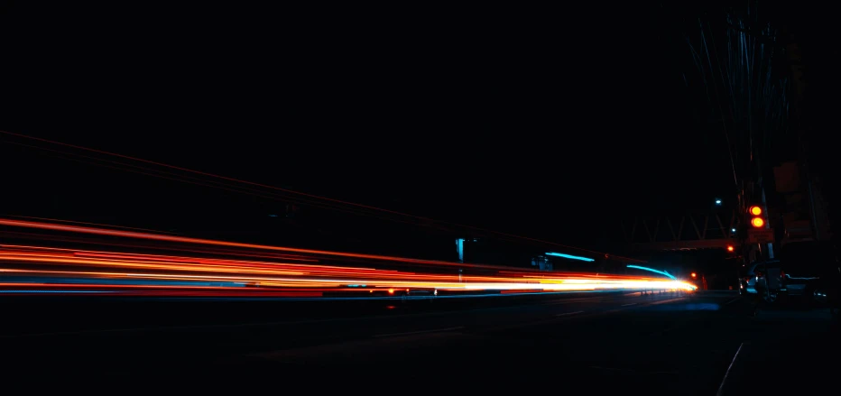 a blurry image of a city street at night, an album cover, by Niko Henrichon, unsplash, visual art, speed lines, amoled wallpaper, orange teal lighting, car moving fast