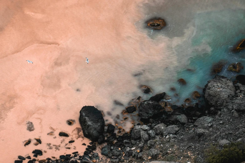 the view of the beach from above shows an area where small rocks have been placed