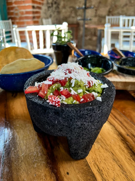 a close up of a bowl of food on a table, calavera, slate, small, regular sized