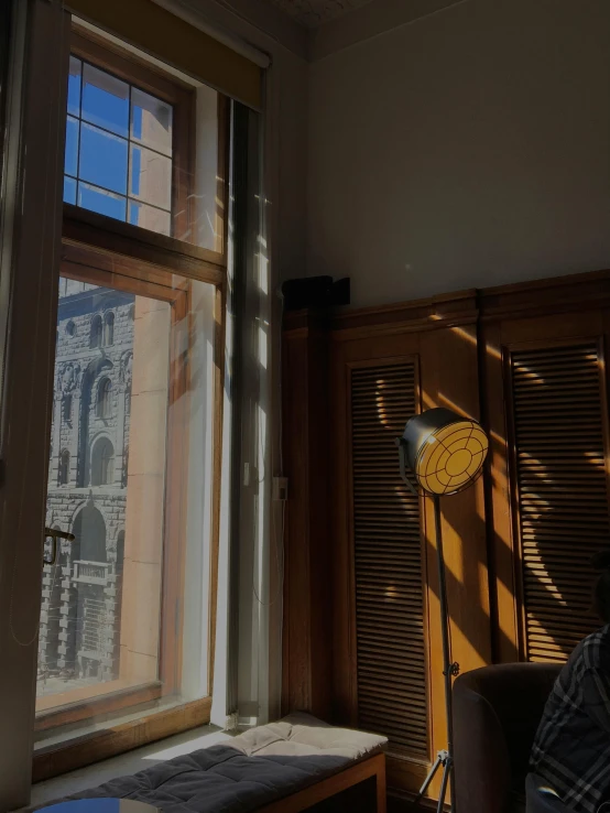 sunlight shining through windows onto a room with large windows