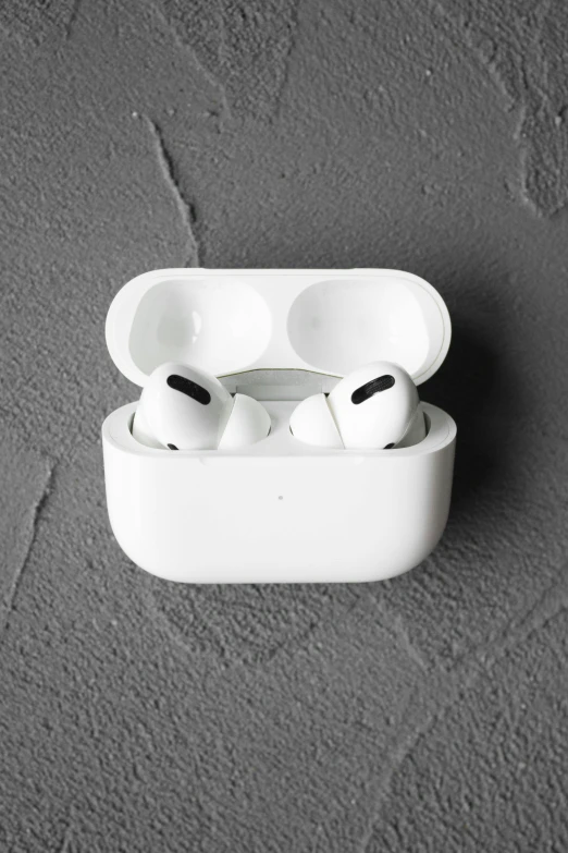 a pair of airpods sitting on top of a table, a black and white photo, plain background, white face paint, product image, aeroplane