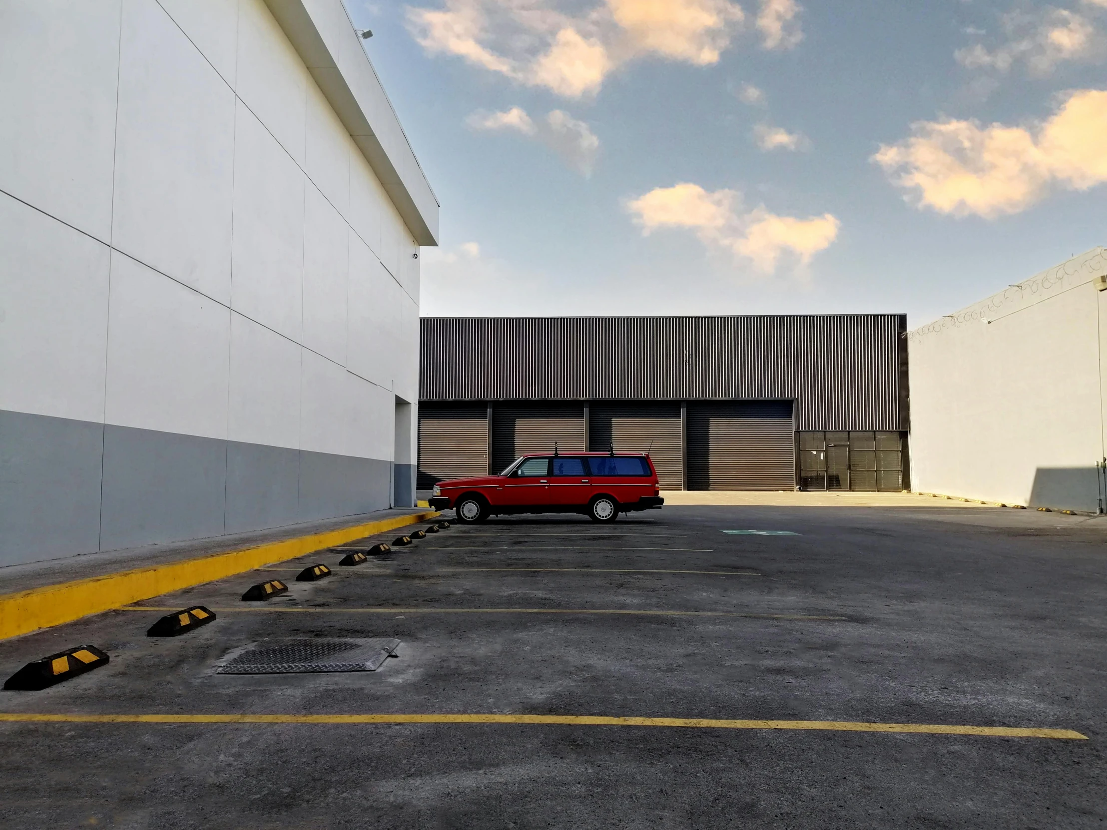 a red and white truck parked in the middle of a parking lot